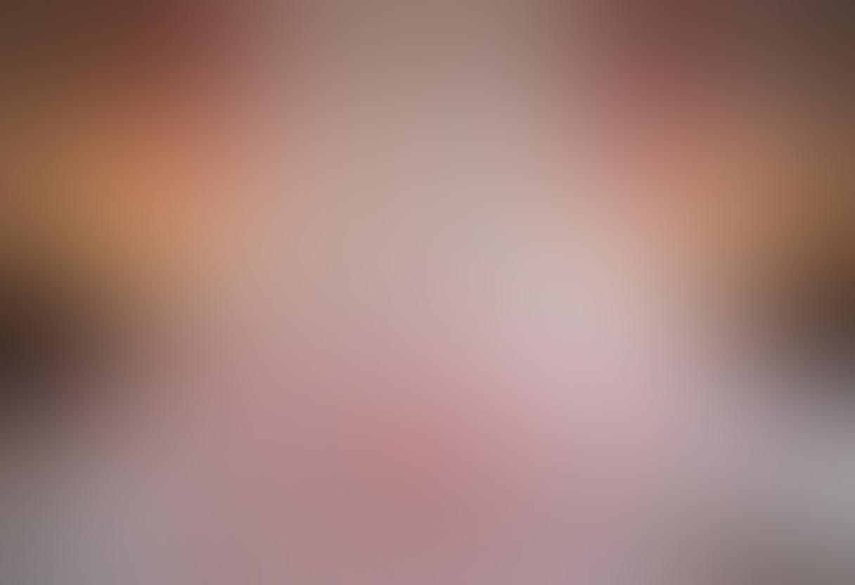 A serene, intimate bedroom setting bathed in soft, warm light, with two intertwined bodies embracing, surrounded by delicate rose petals and flickering candles that symbolize passion. Incorporate playful elements like feathers or silk sheets to enhance the sensuality of the scene. Background hints of cozy ambiance with a hint of abstract forms representing emotional connection and joy. super-realistic. soft focus. warm color palette.